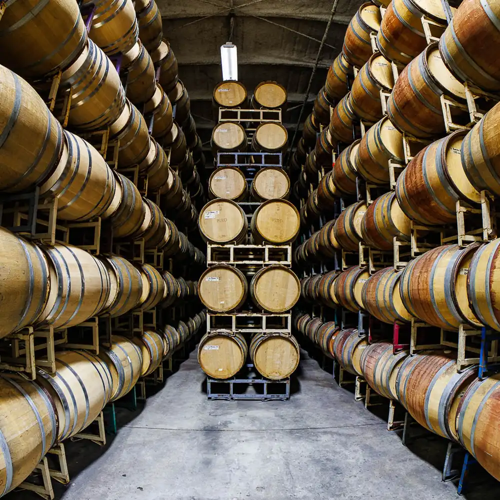 barrels stacked high for aging at Au Bon Climat winery in Santa Maria