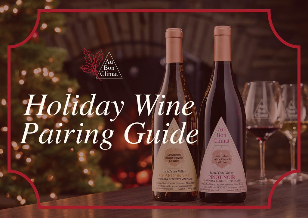 Au Bon Climat Holiday Wine Pairing Guide featuring Sanford & Benedict Vineyard Chardonnay and Pinot Noir beside festive wine glasses, a glowing Christmas tree, and a warm fireplace.